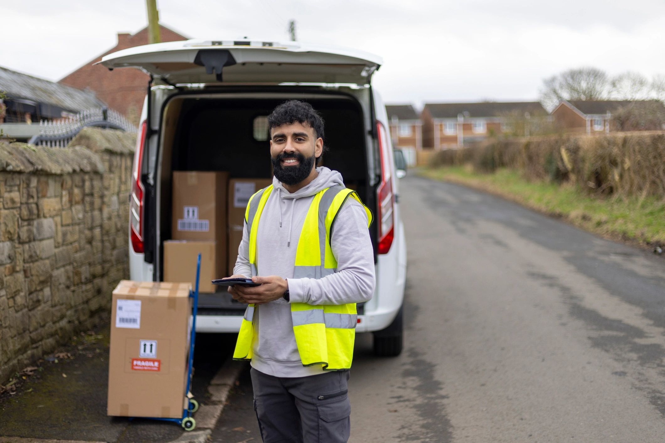 Moving professional standing beside a delivery van